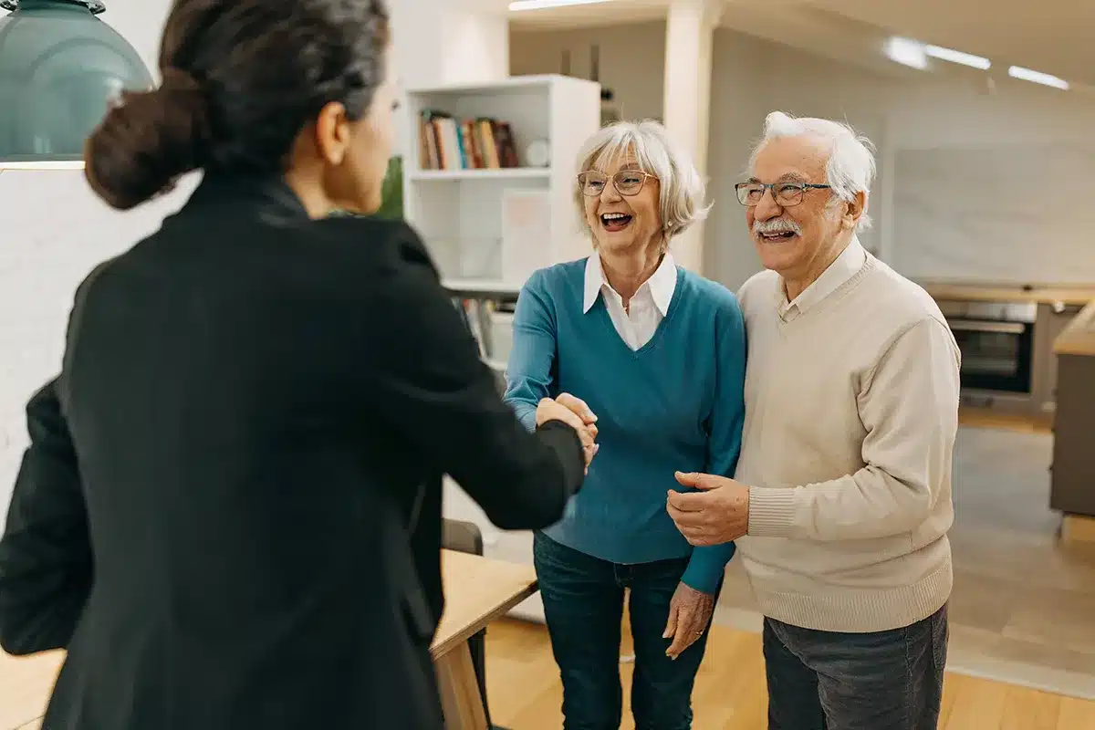 Person shakes hands with residents