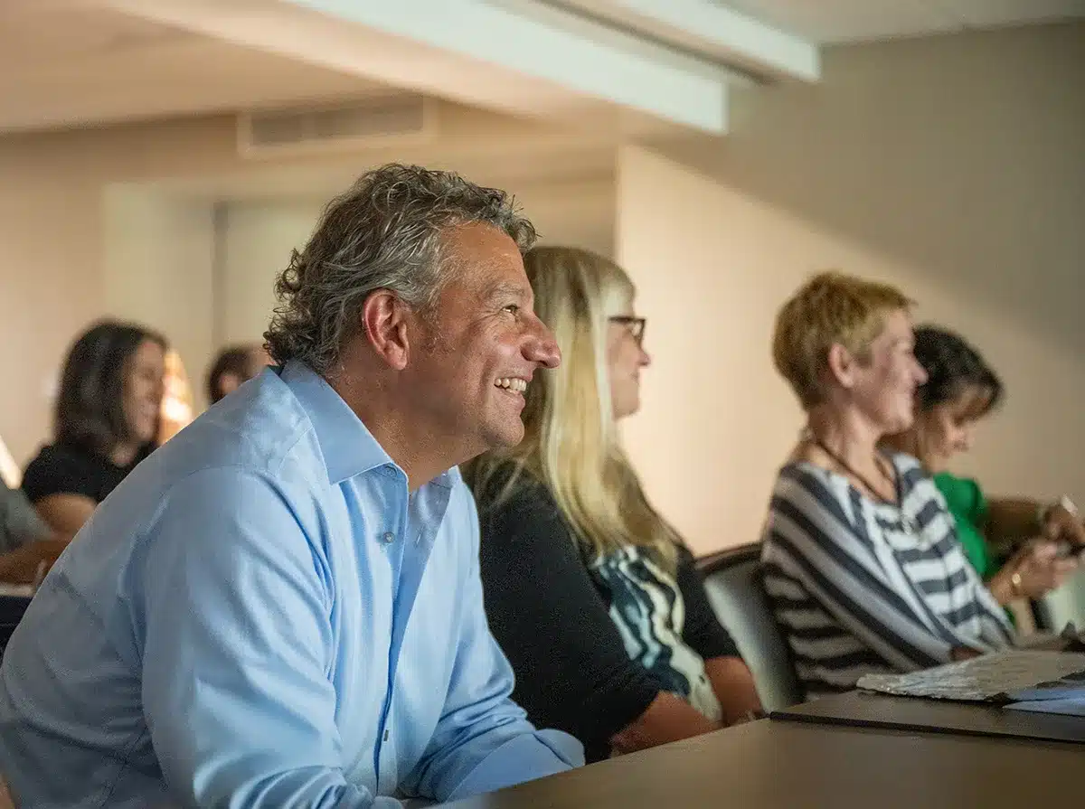 team from Solutions Advisors watching presentation